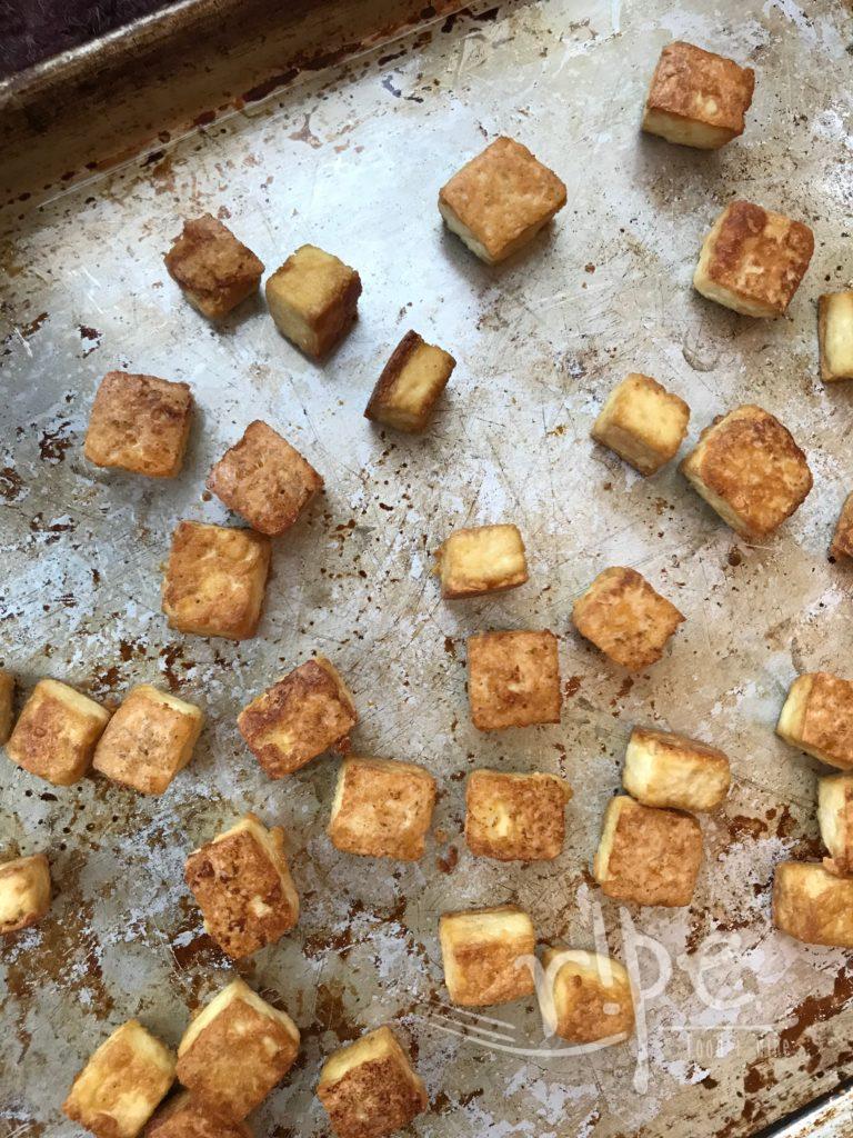 Sheet pan of crispy tofu squares, golden brown